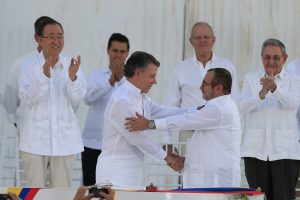 El presidente de Colombia, Juan Manuel Santos (c-i) y máximo líder de las Fuerzas Armadas Revolucionarias de Colombia (FARC), Rodrigo Londoño Echeverri (c-d), alias "Timochenko", se saludan tras firmar el acuerdo de paz hoy, lunes 26 de septiembre de 2016, en la ciudad de Cartagena (Colombia). Santos y Londoño Echeverri firmaron hoy el acuerdo de paz que pone fin a más de medio siglo de conflicto armado. El acuerdo es fruto de casi cuatro años de diálogos entre el Gobierno y las FARC en La Habana y fue sellado en Cartagena de Indias ante más de 2.500 invitados, entre ellos unos 15 presidentes y el rey Juan Carlos. Foto EFE