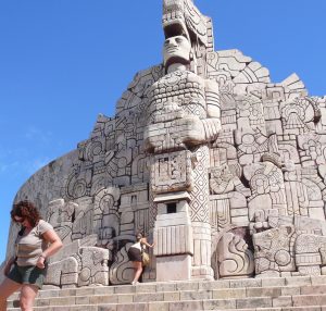 Tourists scamper around a Maya monument in Merida.